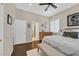 Bedroom with a ceiling fan, dark wood floors, gray walls, and a bed with a bench at the end at 337 Glenridding St, Las Vegas, NV 89183