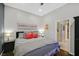 Bedroom with dark wood floors, gray walls, a ceiling fan and bed with orange accent pillows at 337 Glenridding St, Las Vegas, NV 89183