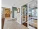 Hallway showcasing stylish tile flooring, neutral paint, and an office space beyond double doors at 337 Glenridding St, Las Vegas, NV 89183