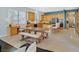 Open-concept living space features a kitchen, dining table, and desk with natural light at 337 Glenridding St, Las Vegas, NV 89183