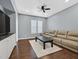 Relaxing living room showcases a leather sofa, ceiling fan, and a patterned area rug at 337 Glenridding St, Las Vegas, NV 89183