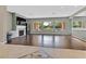 Open living room with hardwood floors, fireplace, and large windows overlooking the backyard at 337 Glenridding St, Las Vegas, NV 89183
