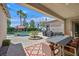 Outdoor patio with a dining area, swimming pool, and lush landscaping at 337 Glenridding St, Las Vegas, NV 89183