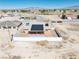 A panoramic view highlights a home with solar panels, a pool, a privacy fence, and desert landscaping in a serene community at 3424 Mount Charleston Dr, Pahrump, NV 89048
