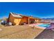 Backyard featuring refreshing pool with lounge area, gravel landscaping, and mountain views in the distance at 3424 Mount Charleston Dr, Pahrump, NV 89048