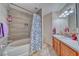 Bright bathroom featuring tile flooring, wooden vanity with white countertops, and a shower with a shower/tub combo at 3424 Mount Charleston Dr, Pahrump, NV 89048