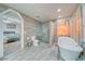This primary bathroom features tile floors and walls, separate tub and walk-in shower at 3424 Mount Charleston Dr, Pahrump, NV 89048