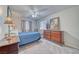 Relaxing bedroom with carpet flooring, a ceiling fan, wood furniture, and large windows for optimal natural lighting at 3424 Mount Charleston Dr, Pahrump, NV 89048