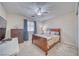 Comfortable bedroom with carpet flooring, a ceiling fan, a wooden bed frame, and lots of natural light at 3424 Mount Charleston Dr, Pahrump, NV 89048
