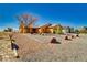 Expansive desert property featuring drought-tolerant landscaping and a charming single-story home at 3424 Mount Charleston Dr, Pahrump, NV 89048