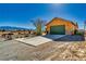 Single-story desert home with a two-car garage and minimalist landscaping at 3424 Mount Charleston Dr, Pahrump, NV 89048