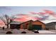 Charming single-story home with desert landscaping and a two-car garage at sunset at 3424 Mount Charleston Dr, Pahrump, NV 89048