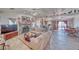 Open living room with stone fireplace, wood-look floors, and seamless flow into the adjacent kitchen at 3424 Mount Charleston Dr, Pahrump, NV 89048