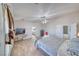 Bright main bedroom featuring wood-look flooring, a ceiling fan, and access to an ensuite bathroom at 3424 Mount Charleston Dr, Pahrump, NV 89048