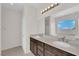 Bathroom featuring double sinks, a large mirror, and modern lighting fixtures at 367 Wilford Springs St, Henderson, NV 89014