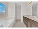 Bathroom featuring double sinks, soaking tub, and a separate shower stall at 367 Wilford Springs St, Henderson, NV 89014