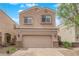 Charming two-story home with a tan stucco exterior, complemented by a two-car garage and a paver driveway at 367 Wilford Springs St, Henderson, NV 89014