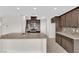 Open-concept kitchen featuring a large granite island, stainless steel appliances, and ample cabinet space at 367 Wilford Springs St, Henderson, NV 89014
