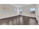 Bright living room featuring dark wood floors and multiple windows at 367 Wilford Springs St, Henderson, NV 89014