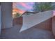 Enclosed backyard featuring desert landscaping and a brick privacy wall, perfect for outdoor entertaining at 393 Desert Cadence St, Henderson, NV 89011
