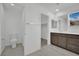 Bathroom featuring tile floor, double sink vanity, toilet, and closet at 393 Desert Cadence St, Henderson, NV 89011
