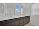 Bathroom vanity with double sinks, large mirror, and natural light at 393 Desert Cadence St, Henderson, NV 89011