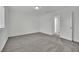 Bedroom featuring neutral carpet, white walls, and ensuite bathroom at 393 Desert Cadence St, Henderson, NV 89011