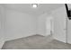 This bedroom features neutral carpeting, crisp white walls, and an open doorway leading to another room at 393 Desert Cadence St, Henderson, NV 89011