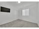 Bedroom features neutral carpet, a window with blinds, and a closet with white doors for storage at 393 Desert Cadence St, Henderson, NV 89011