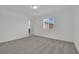 Bright bedroom with gray carpet, natural light, and ensuite bathroom at 393 Desert Cadence St, Henderson, NV 89011