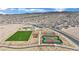 A lovely community park featuring tennis courts, a vibrant green field, and shaded picnic areas at 393 Desert Cadence St, Henderson, NV 89011