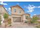 Charming two-story home featuring desert landscaping, a neutral color scheme, and an attached two-car garage at 393 Desert Cadence St, Henderson, NV 89011