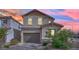 Charming two-story home featuring a two-car garage, desert landscaping, and a paver driveway at 393 Desert Cadence St, Henderson, NV 89011
