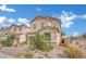 Charming two-story home featuring desert landscaping, a neutral color scheme, and an attached two-car garage at 393 Desert Cadence St, Henderson, NV 89011