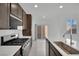Contemporary kitchen featuring white countertops, stainless steel appliances, and dark cabinets at 393 Desert Cadence St, Henderson, NV 89011