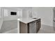 Kitchen island with stainless steel sink and appliances, with an open-concept living area at 393 Desert Cadence St, Henderson, NV 89011