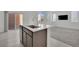 Kitchen island with stainless steel sink and hardware, with an open-concept living area at 393 Desert Cadence St, Henderson, NV 89011
