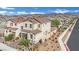 Exterior shot of home exhibiting meticulous landscaping, desert accents, and a two-car garage at 393 Desert Cadence St, Henderson, NV 89011