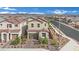 Beautiful street view showcasing detailed landscaping, a brick driveway, and two-car garage at 393 Desert Cadence St, Henderson, NV 89011