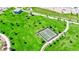 Aerial view of community tennis courts, set within a well-manicured park and green spaces for active residents at 393 Desert Cadence St, Henderson, NV 89011