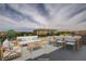 Cozy rooftop terrace with comfortable seating and dining area overlooking a manicured landscape at 3980 Heron Fairway Dr, Las Vegas, NV 89141