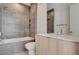 Modern bathroom with gray tile shower, bathtub, and sleek vanity at 3980 Heron Fairway Dr, Las Vegas, NV 89141