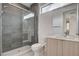 Modern bathroom with a glass-enclosed shower, toilet, and vanity with a sink at 3980 Heron Fairway Dr, Las Vegas, NV 89141