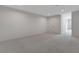 Spacious carpeted bedroom with neutral tones, including a doorway leading to another room at 3980 Heron Fairway Dr, Las Vegas, NV 89141