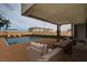 Inviting covered patio overlooking the pool and backyard, furnished with comfortable seating for outdoor entertaining at 3980 Heron Fairway Dr, Las Vegas, NV 89141