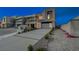 Modern home exterior featuring a clean design, a spacious driveway, and well-maintained landscaping at 3980 Heron Fairway Dr, Las Vegas, NV 89141