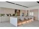 Modern kitchen with a large island, bar seating, and stainless steel appliances at 3980 Heron Fairway Dr, Las Vegas, NV 89141