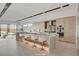 Bright, open kitchen with island, modern appliances, bar stools and backyard views at 3980 Heron Fairway Dr, Las Vegas, NV 89141