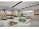 Bright living area with sleek floors, modern furniture, and sliding doors providing access to the backyard at 3980 Heron Fairway Dr, Las Vegas, NV 89141