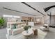 Modern living area with stylish furniture, an open staircase, and a well-appointed kitchen in the background at 3980 Heron Fairway Dr, Las Vegas, NV 89141